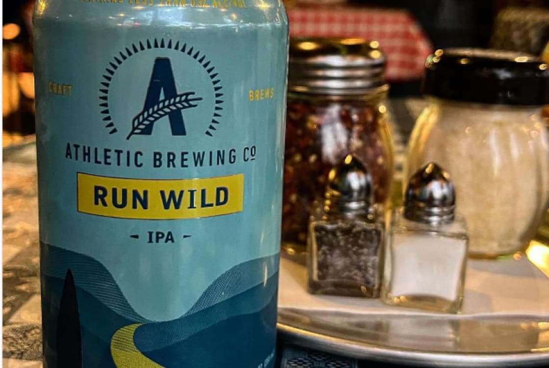 Atheltic brewing run wild IPA on a table beside some salt shakers
