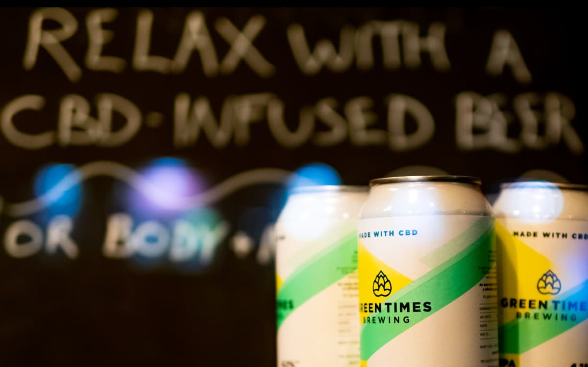 3 cbd infused non-alcoholic beers with the text "relax with cbd infused beers" in the background